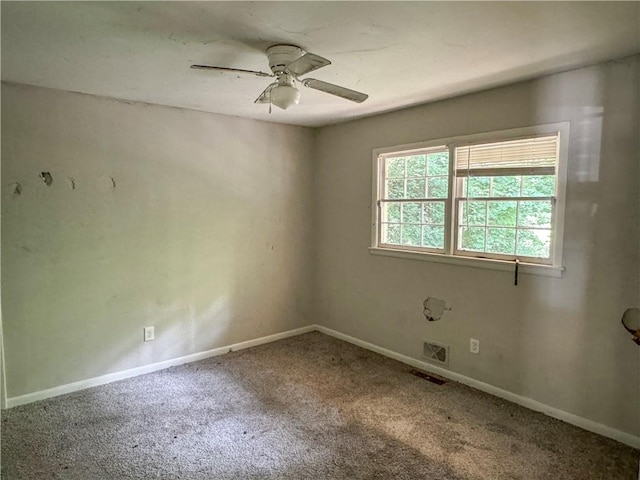 spare room with ceiling fan and carpet