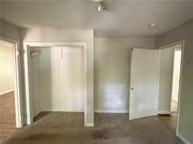 unfurnished bedroom with dark carpet