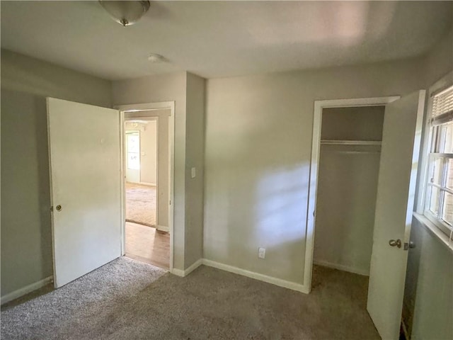 unfurnished bedroom with a closet and carpet floors