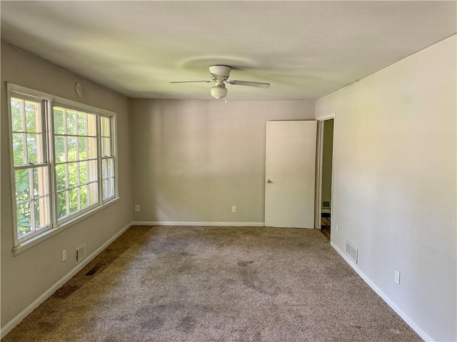 empty room with carpet floors and ceiling fan