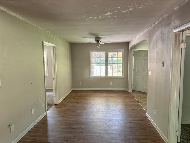 spare room with ceiling fan and dark hardwood / wood-style flooring