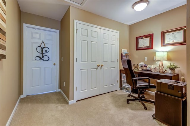 office space featuring baseboards and light colored carpet