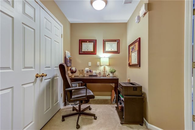 carpeted office with visible vents and baseboards