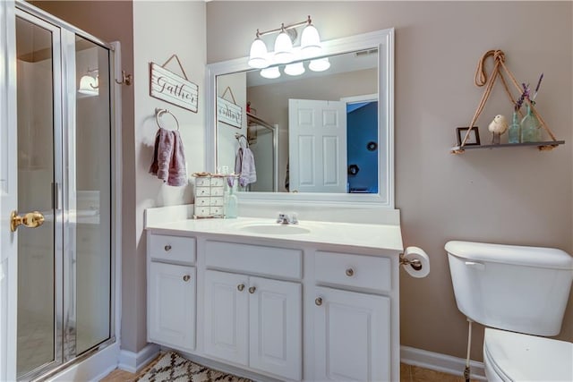 full bathroom featuring a shower stall, toilet, vanity, and baseboards