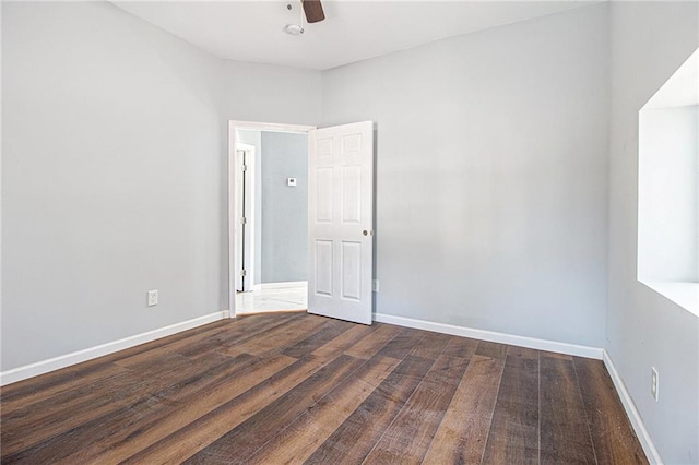 unfurnished room featuring dark hardwood / wood-style floors and ceiling fan