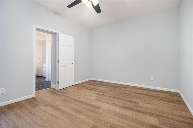 empty room with hardwood / wood-style floors and ceiling fan