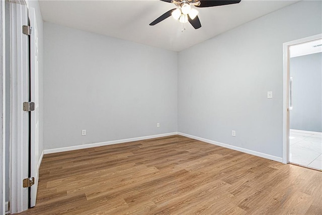 empty room featuring ceiling fan and light hardwood / wood-style flooring