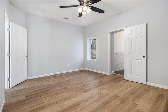 unfurnished bedroom featuring ceiling fan, light hardwood / wood-style floors, and ensuite bath