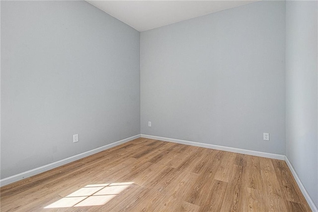 empty room with light hardwood / wood-style flooring