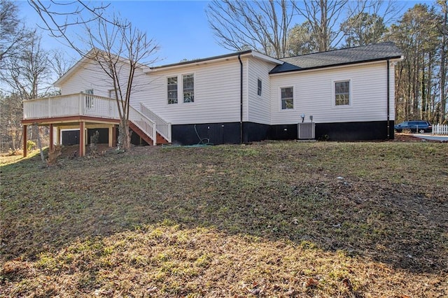 rear view of property featuring a yard, central air condition unit, and a deck