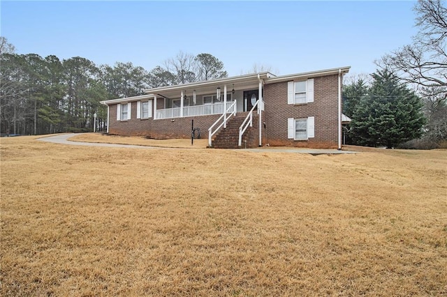 ranch-style house with brick siding, stairway, a porch, and a front yard