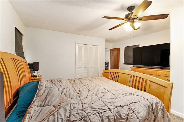 carpeted bedroom with a closet and ceiling fan