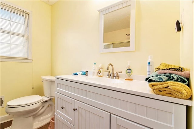 full bathroom with toilet and vanity