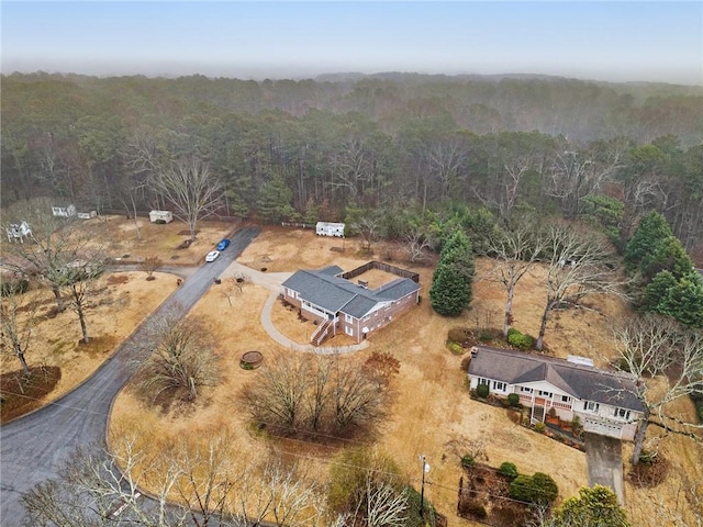 aerial view featuring a wooded view