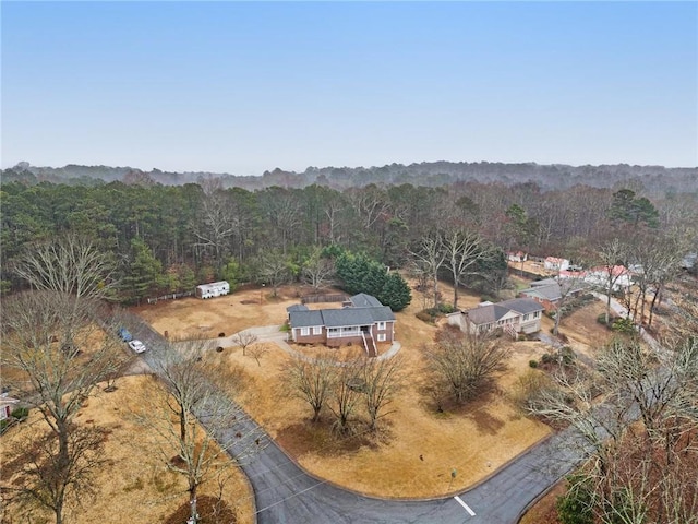 drone / aerial view featuring a forest view