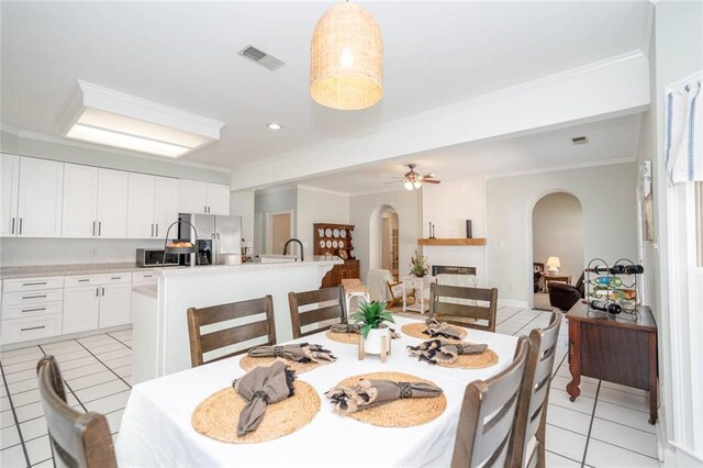 dining area featuring light tile patterned floors, ceiling fan, and ornamental molding