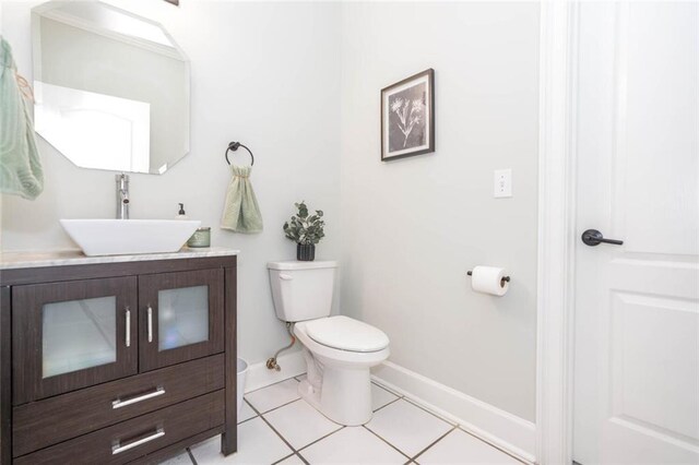 bathroom featuring tile patterned flooring, vanity, and toilet