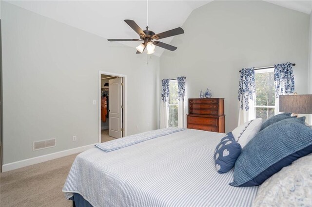 carpeted bedroom featuring high vaulted ceiling and ceiling fan