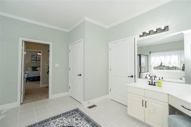 bathroom featuring tile patterned flooring, vanity, and ornamental molding