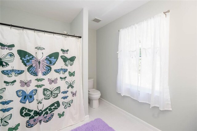 bathroom with tile patterned flooring and toilet