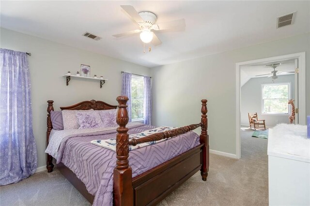 bedroom with ceiling fan, light carpet, and vaulted ceiling