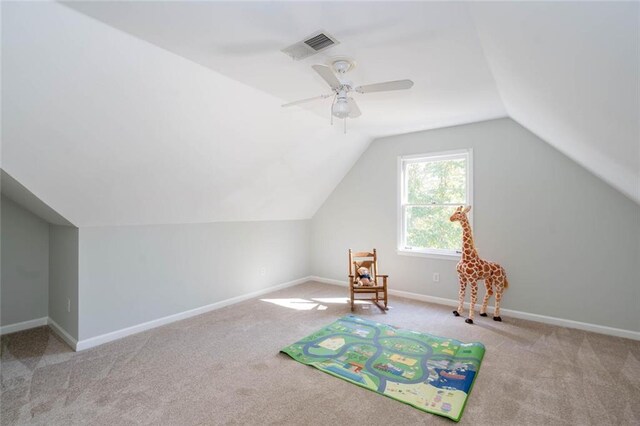 recreation room featuring light colored carpet, ceiling fan, and lofted ceiling