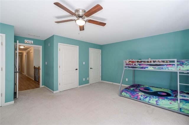 carpeted bedroom with ceiling fan