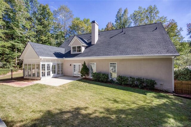 back of house with a lawn, french doors, and a patio