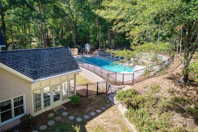 view of pool featuring a storage shed