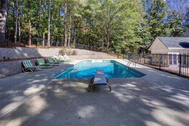 view of swimming pool with a patio area