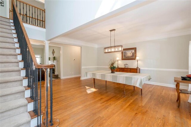 interior space featuring crown molding and light hardwood / wood-style floors