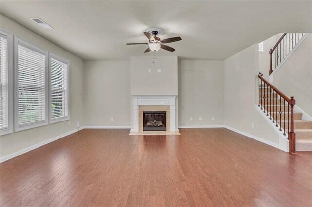 1354 Slate Bend Dr, Dacula, GA 30019 - unfurnished living room featuring ceiling fan, hardwood / wood-style floors, and a high end fireplace