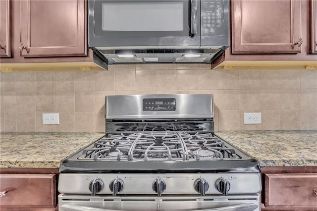 1354 Slate Bend Dr, Dacula, GA 30019 - kitchen featuring backsplash, gas stove, and light stone counters