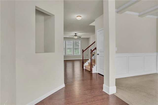 corridor with dark carpet and beam ceiling