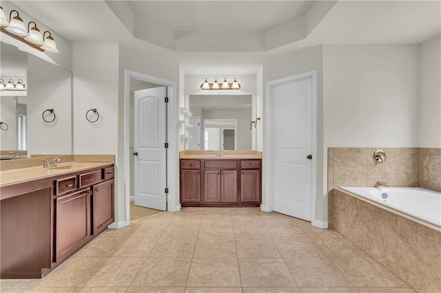 1354 Slate Bend Dr, Dacula, GA 30019 - bathroom featuring vanity, a raised ceiling, tiled bath, and tile patterned flooring