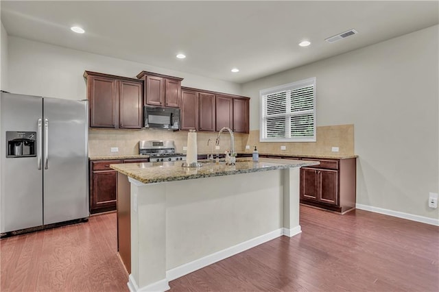1354 Slate Bend Dr, Dacula, GA 30019 - kitchen featuring dark hardwood / wood-style flooring, sink, a center island with sink, and stainless steel appliances