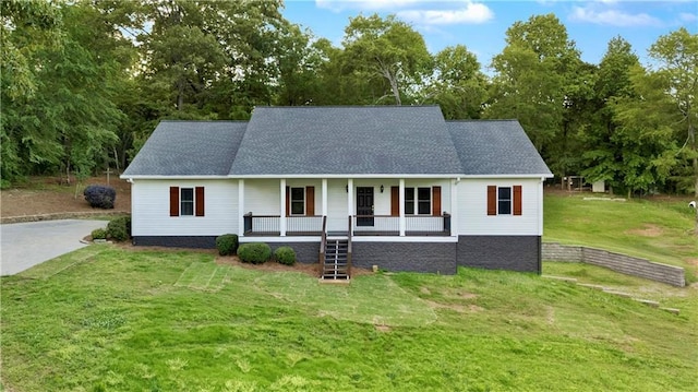 view of front of property with a porch, a front lawn, stairway, roof with shingles, and view of scattered trees