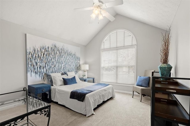 carpeted bedroom featuring vaulted ceiling, ceiling fan, a textured ceiling, and baseboards