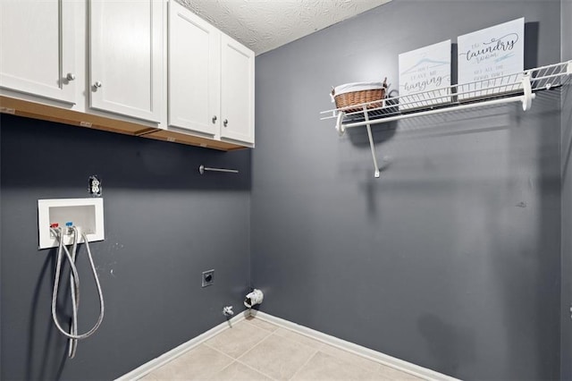 laundry area featuring a textured ceiling, gas dryer hookup, hookup for a washing machine, cabinet space, and electric dryer hookup