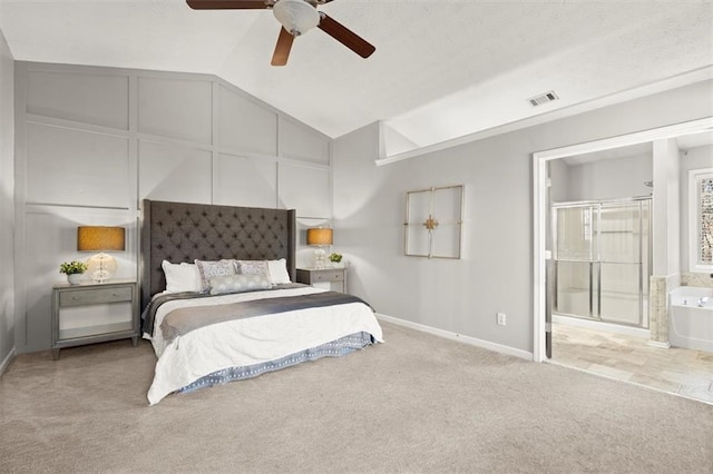 bedroom with lofted ceiling, ensuite bathroom, light carpet, visible vents, and baseboards