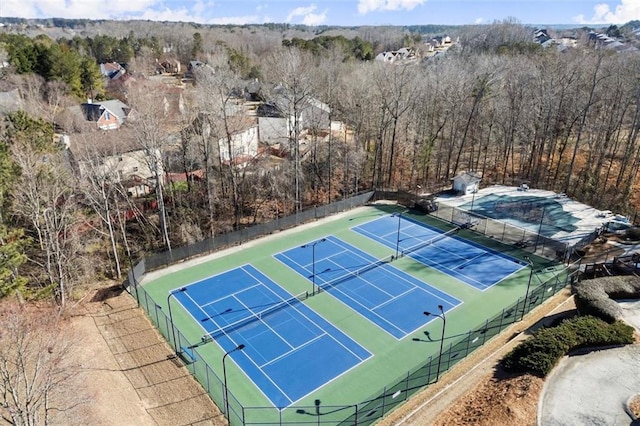 view of sport court featuring fence