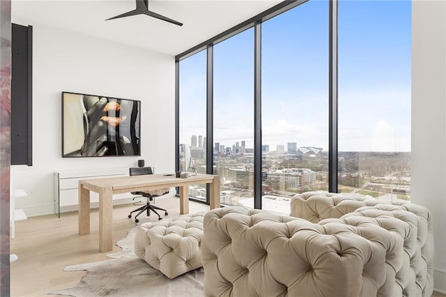 788 W Marietta St Unit 1809, Atlanta, GA 30318 - bedroom with multiple windows, expansive windows, an office area, light wood finished floors, and baseboards