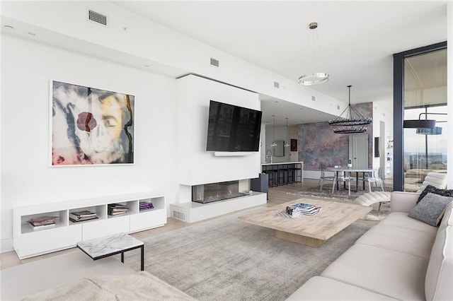 788 W Marietta St Unit 1809, Atlanta, GA 30318 - living room with a glass covered fireplace, wood finished floors, and baseboards