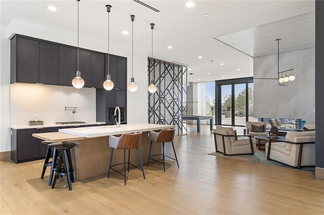 788 W Marietta St Unit 1809, Atlanta, GA 30318 - kitchen with floor to ceiling windows, light countertops, light wood finished floors, a kitchen breakfast bar, and pendant lighting