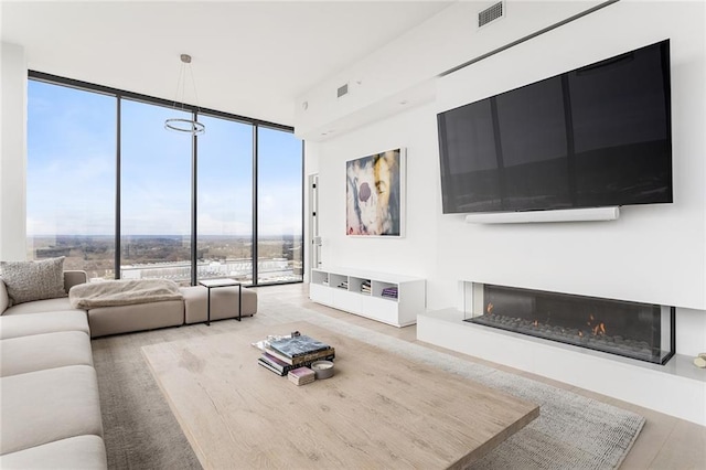 788 W Marietta St Unit 1809, Atlanta, GA 30318 - living room with expansive windows, a glass covered fireplace, and wood finished floors