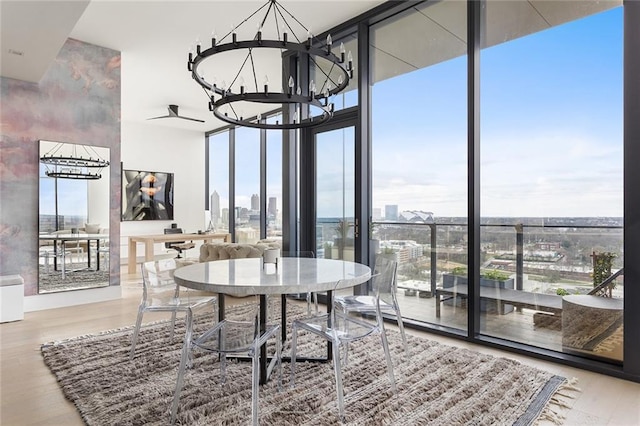 788 W Marietta St Unit 1809, Atlanta, GA 30318 - dining space with a chandelier, expansive windows, wood finished floors, and a city view