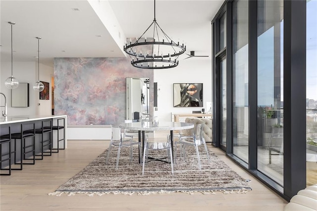 788 W Marietta St Unit 1809, Atlanta, GA 30318 - dining room featuring a chandelier, light wood-type flooring, plenty of natural light, a wall of windows, and an accent wall