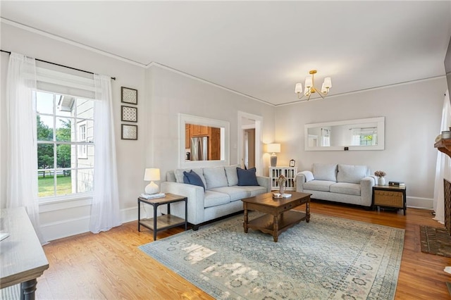 67 Trammell St SW, Marietta, GA 30064 - living area with a chandelier, crown molding, light wood finished floors, and baseboards