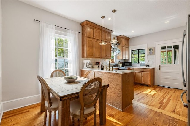 67 Trammell St SW, Marietta, GA 30064 - kitchen with brown cabinets, light wood-type flooring, plenty of natural light, light countertops, and recessed lighting