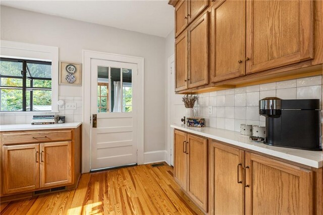 67 Trammell St SW, Marietta, GA 30064 - kitchen featuring healthy amount of natural light, light countertops, and tasteful backsplash